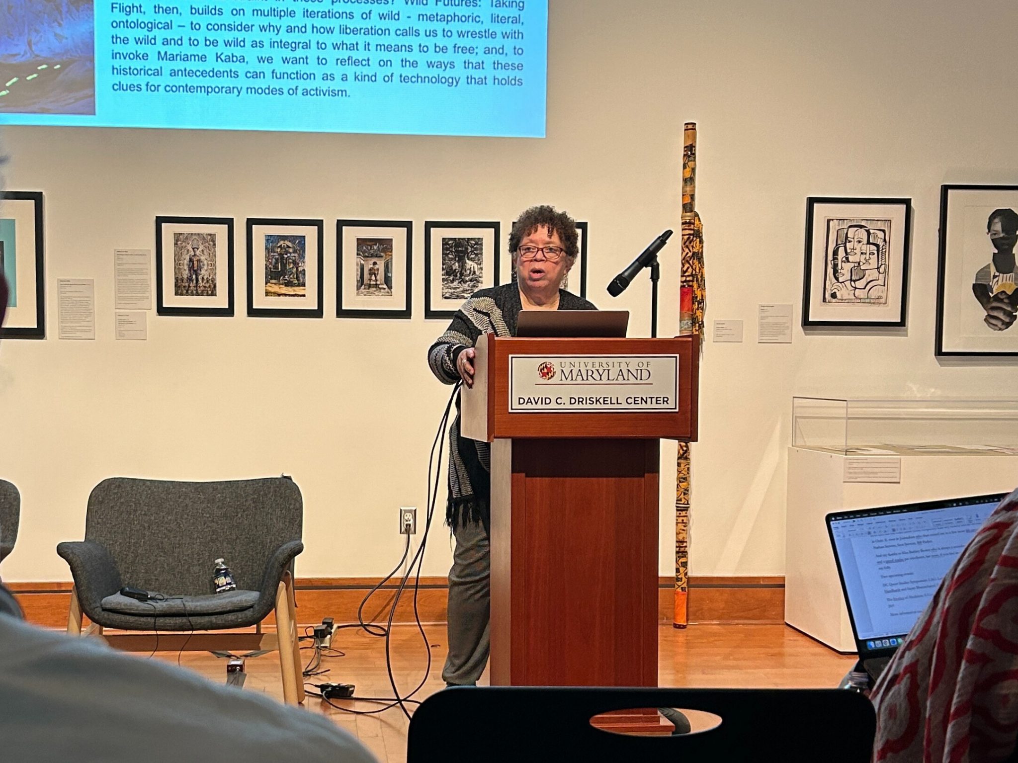Woman speaking into microphone at a podium