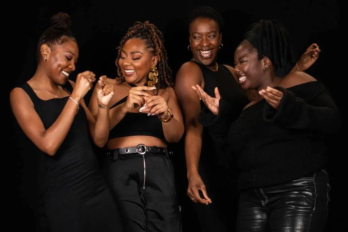 Four women laughing