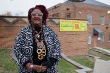 Woman standing in from of Nyumburu Cultural Center sign