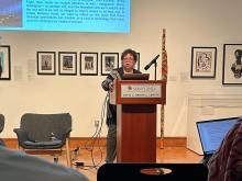 Woman speaking into microphone at a podium