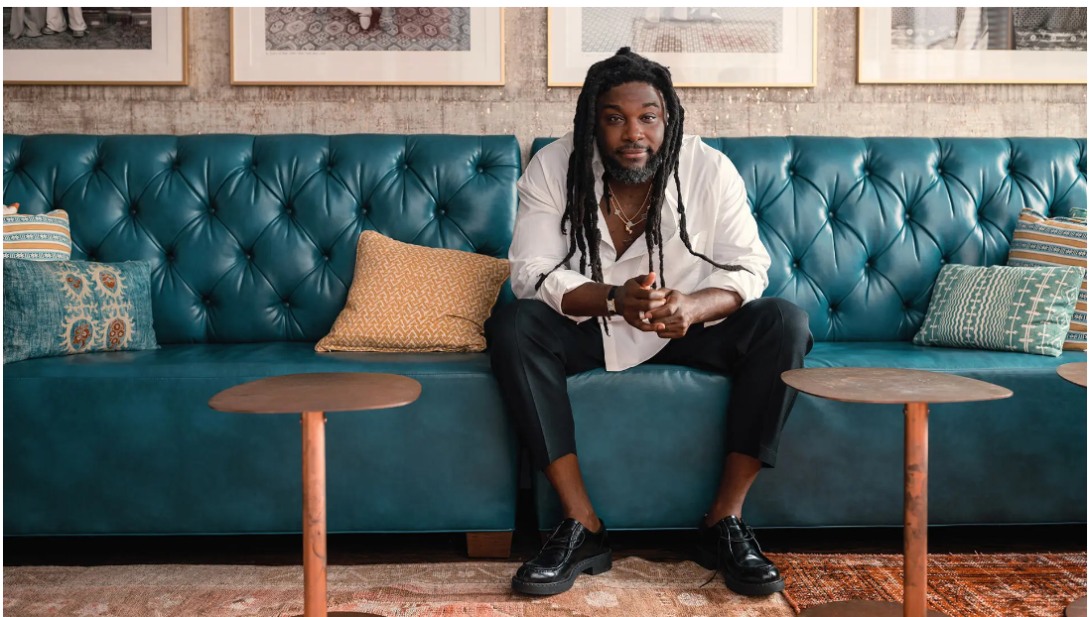 Jason Reynolds sitting on a sofa